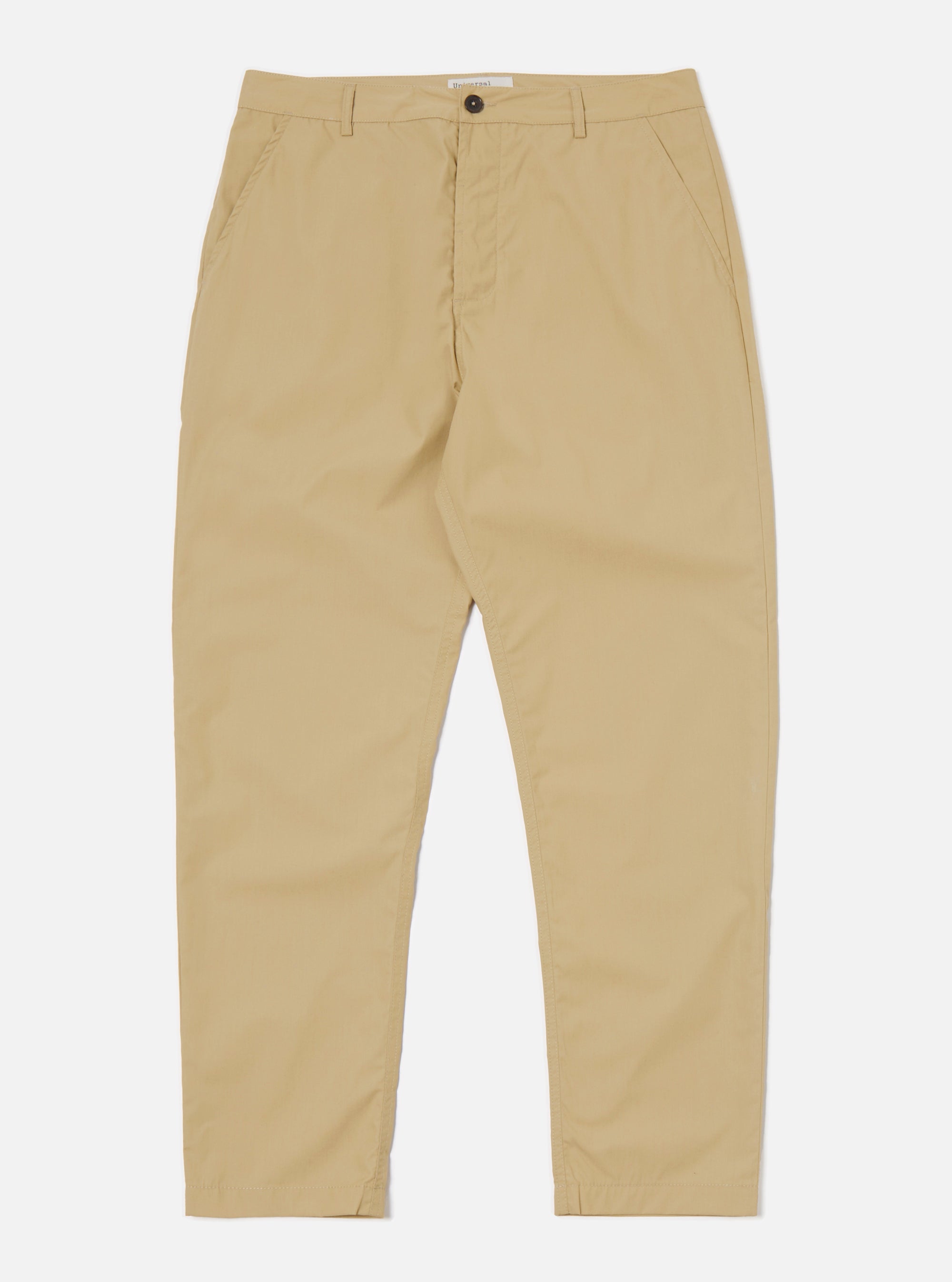 The Sand Recycled Polytech Military Chino is shown as a flat lay against a plain white background. These sand-colored trousers feature a button fly, belt loops, and two front angled pockets. The fabric is a smooth, technical blend of cotton and recycled polyester.