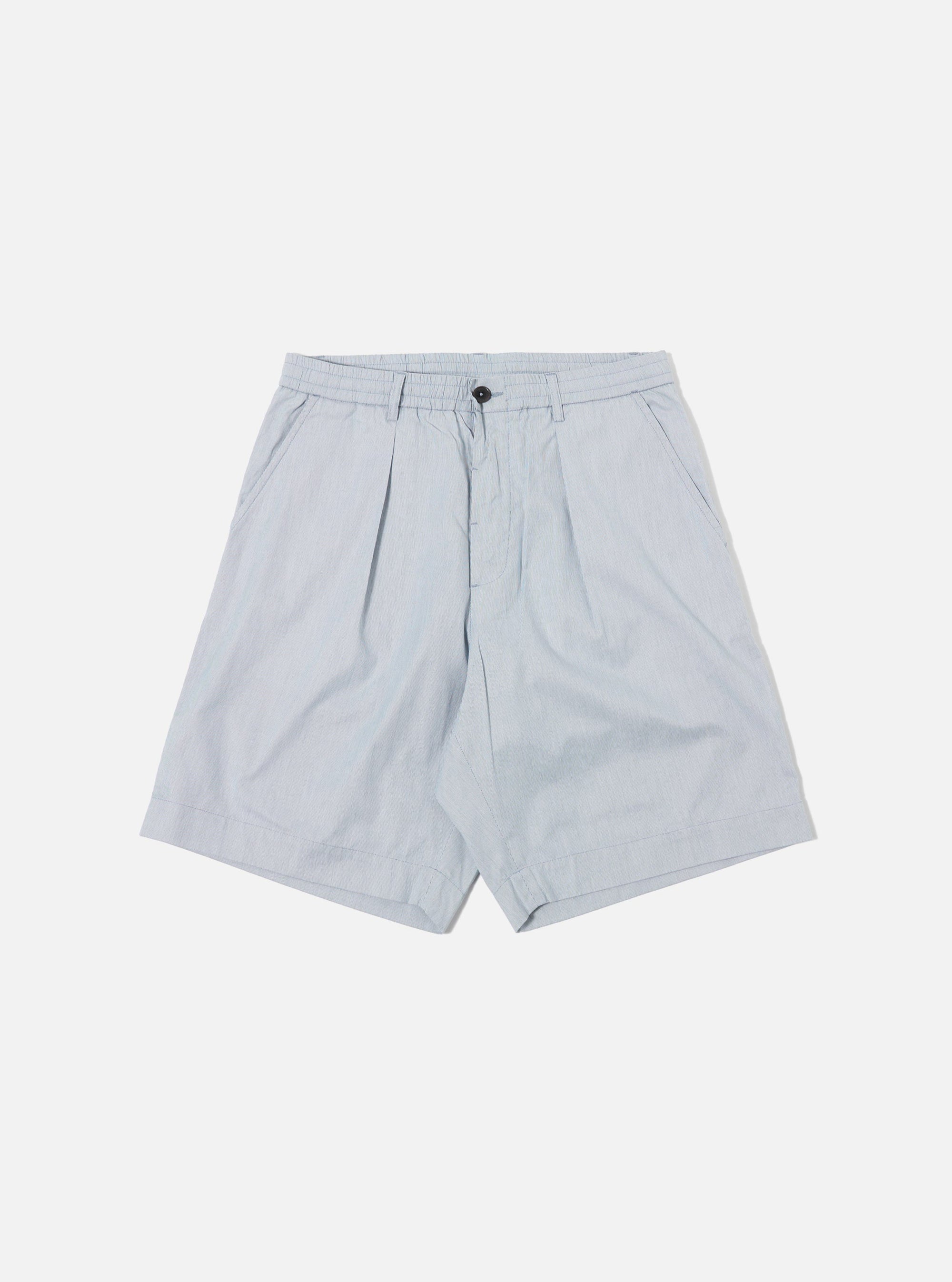The Navy Kennedy Stripe Pleated Track Short is displayed as a flat lay against a plain white background. The shorts feature a navy blue base with a white vertical stripe pattern, an elasticated waistband with a contrasting white drawstring, and a single pleat on each leg. Two side pockets and a relaxed fit are visible.