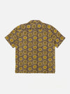The Olive Cape Block Print Camp Shirt is shown from the back as a flat lay against a plain white background. The shirt features a camp collar and short sleeves, with the intricate block print pattern visible across the olive green fabric.