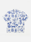 The White Jungle Toile Poplin Camp Shirt is shown as a flat lay against a plain white background. The shirt features an all-over jungle toile print in dark ink on a white base, a relaxed camp collar, a central button-down front, and a single chest pocket on the left side. The short-sleeved garment has a straight hem.