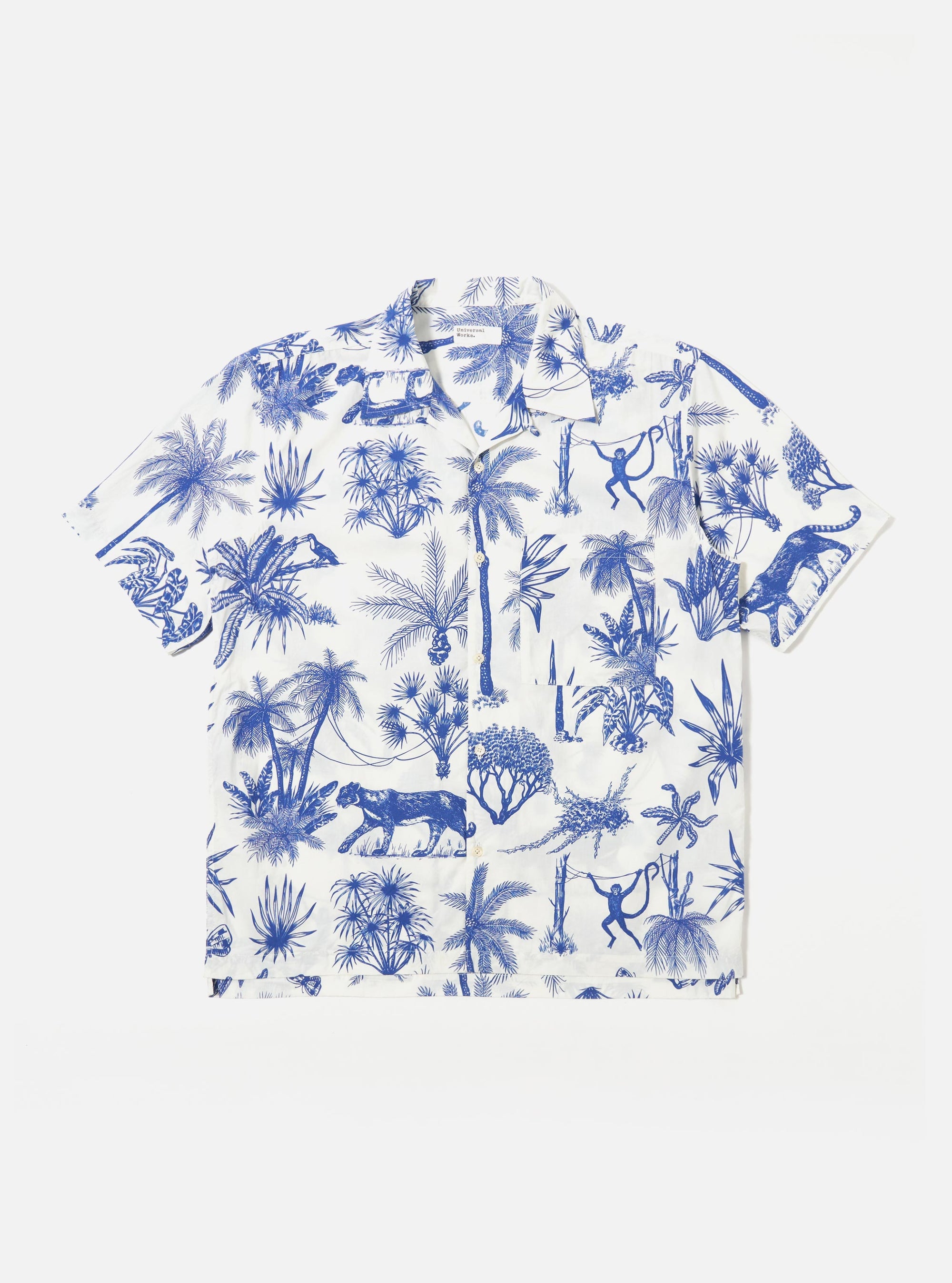 The White Jungle Toile Poplin Camp Shirt is shown as a flat lay against a plain white background. The shirt features an all-over jungle toile print in dark ink on a white base, a relaxed camp collar, a central button-down front, and a single chest pocket on the left side. The short-sleeved garment has a straight hem.