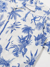 The White Jungle Toile Poplin Camp Shirt is shown from the back as a flat lay against a plain white background. The image highlights the straight hem, the back of the camp collar, and the intricate jungle-themed print featuring dark botanical and animal illustrations on a white base.
