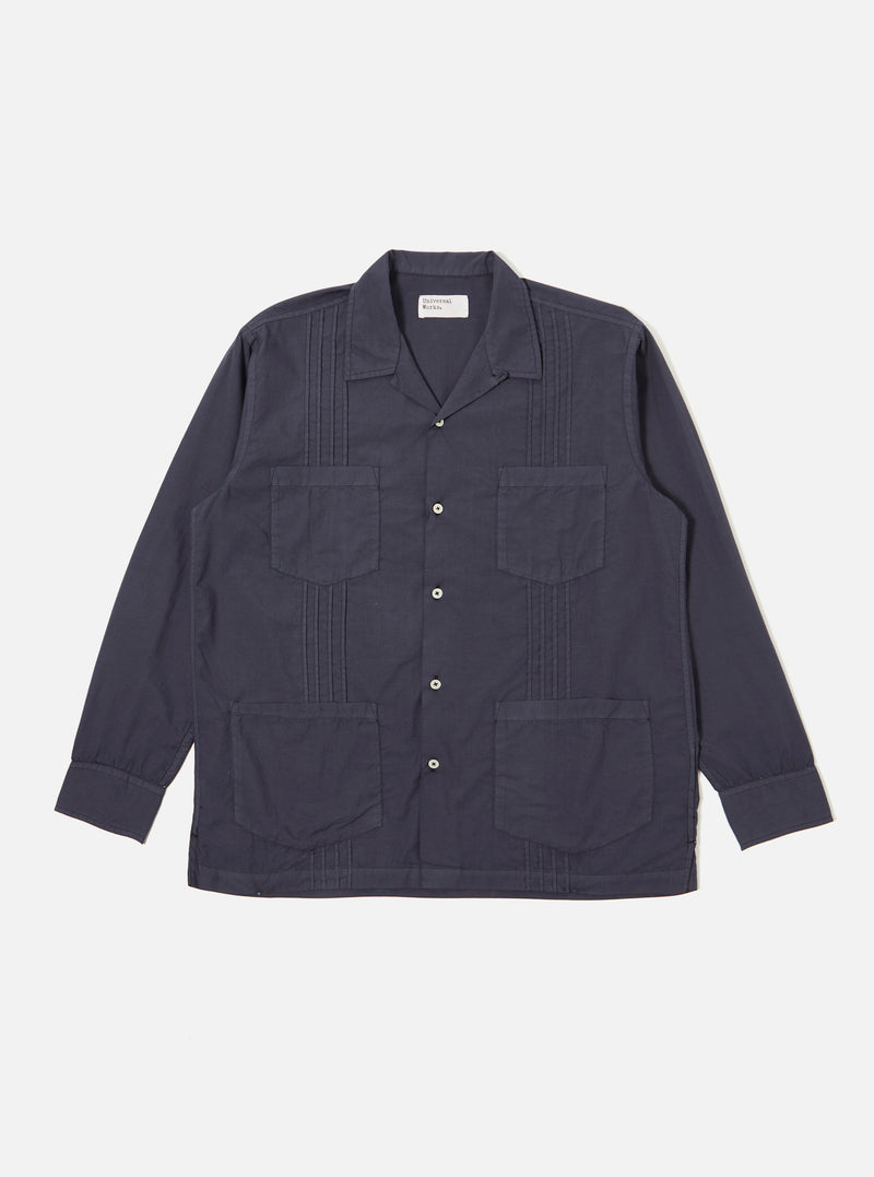 The Navy Poplin Dwight Overshirt is presented as a flat lay against a plain white background. The overshirt features a Cuban collar with loop fastening, a full button-up front, and four large front patch pockets. Vertical pleats run down both sides of the front opening.