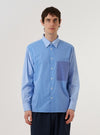 A model wears the Sky/Blue Fil A Fil Mixed Square Pocket Shirt against a plain white background. The shirt features prominent square chest pockets, a button-down front, and a classic collar, showcasing the light blue textured weave of the fabric.