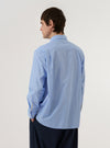 The Sky/Blue Fil A Fil Mixed Square Pocket Shirt is worn by a model against a plain white background. The shirt is shown from a rear three-quarter angle, highlighting the back yoke and the relaxed fit of the sleeves. The model is wearing the shirt untucked over a white t-shirt.
