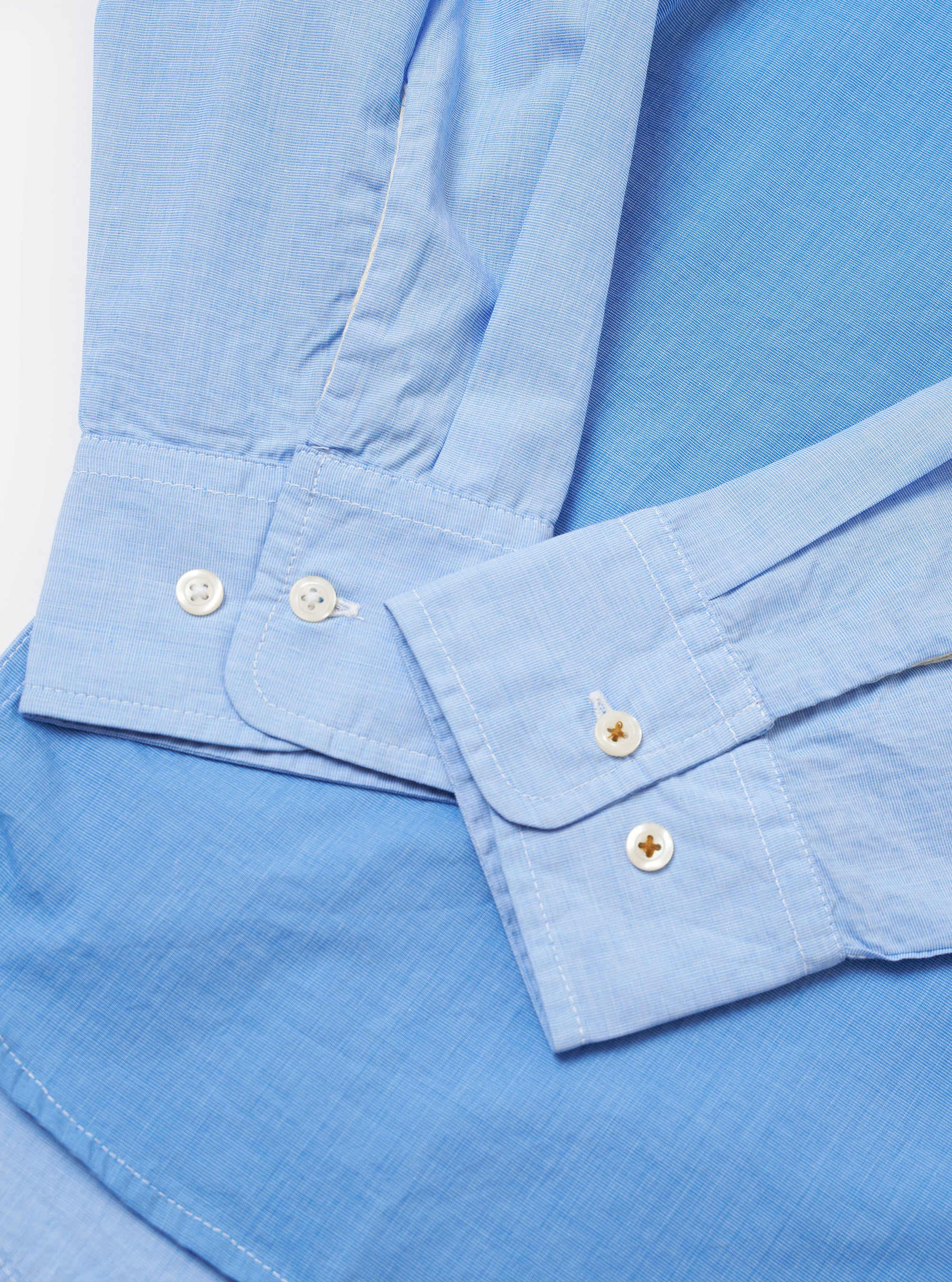 The Sky/Blue Fil A Fil Mixed Square Pocket Shirt is shown from the back as a flat lay against a plain white background. The image highlights the straight hem, the back yoke, and the clean construction of the light blue fil-a-fil fabric.