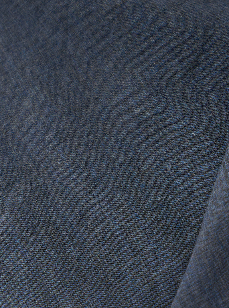 A close-up swatch of the Indigo Fine Organic Cotton Sal Road Shirt highlights the deep indigo blue color and the soft marled texture of the lightweight, loose-weave organic cotton fabric.