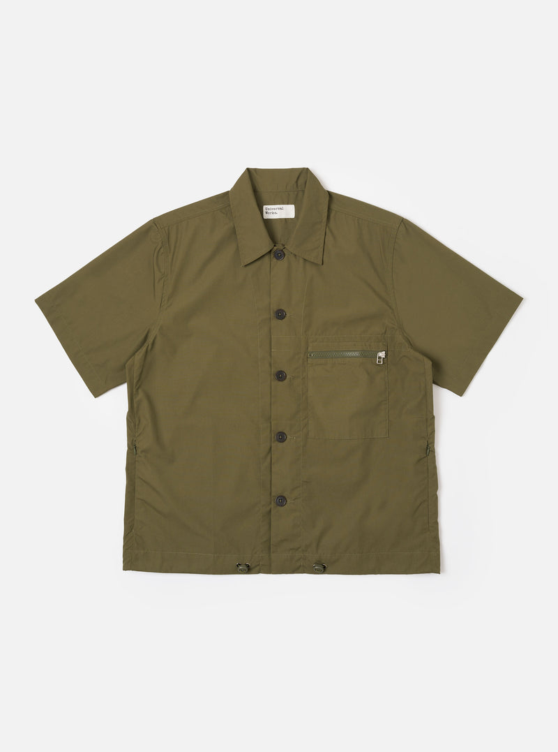 The Olive Recycled Polytech Z Tech Overshirt is shown as a flat lay against a white background. The short-sleeve overshirt features a one-piece collar, a central button-down front, and a single reinforced patch pocket with a zip on the chest. The olive green fabric has a smooth finish and visible stitching details.