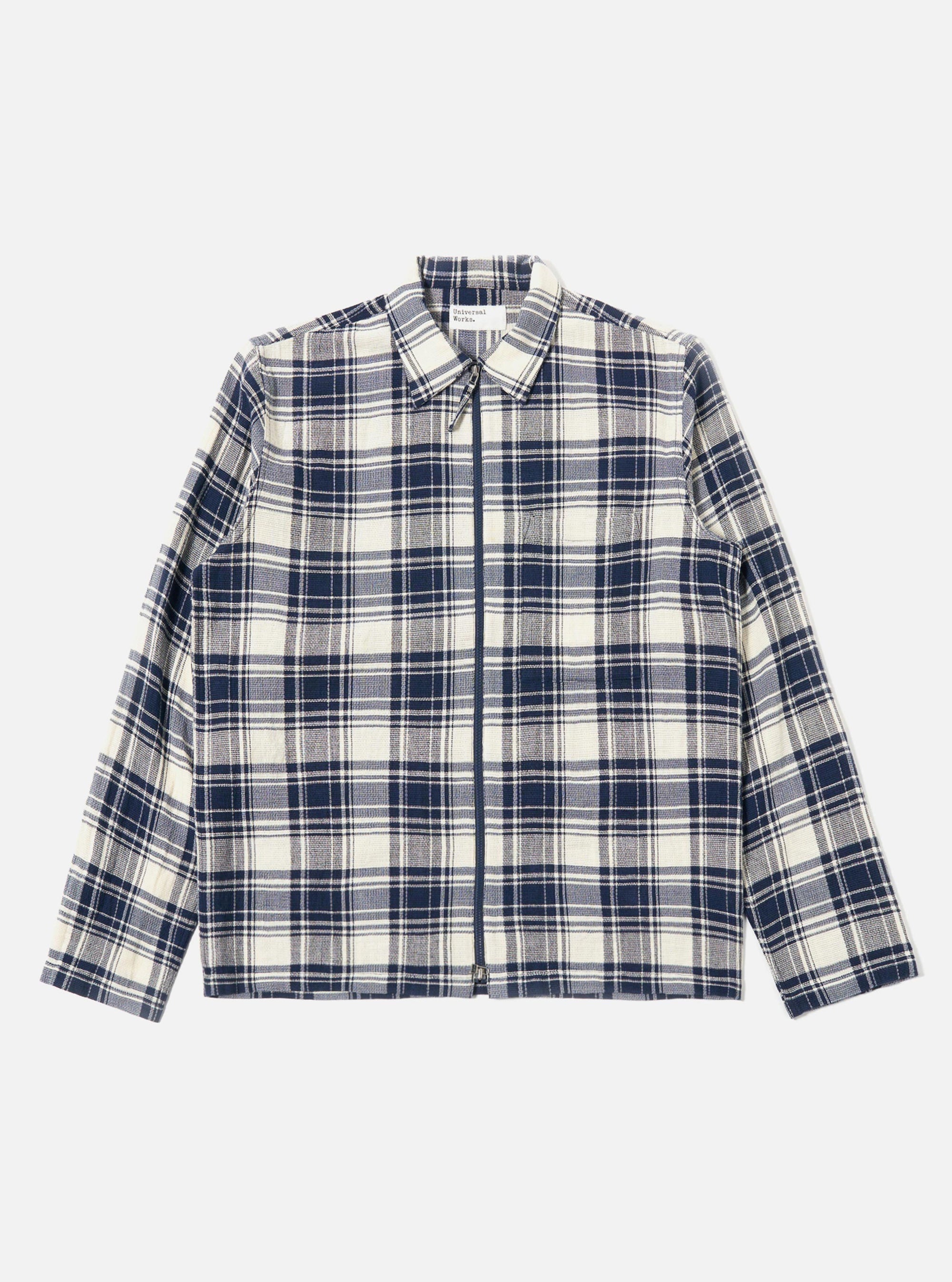 The Navy Texture Plaid Zip Shirt is shown as a flat lay against a plain white background. The shirt features a full-length silver-tone zip closure, a structured pointed collar, and two large patch pockets on the chest. The navy blue fabric displays a distinct textured plaid pattern throughout.