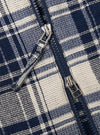 The Navy Texture Plaid Zip Shirt is shown from a rear angle as a flat lay against a plain white background. The image highlights the shirt's relaxed fit, straight hem, and the detailed texture of the navy blue plaid cotton fabric. A simple locker loop is visible at the center of the back yoke.