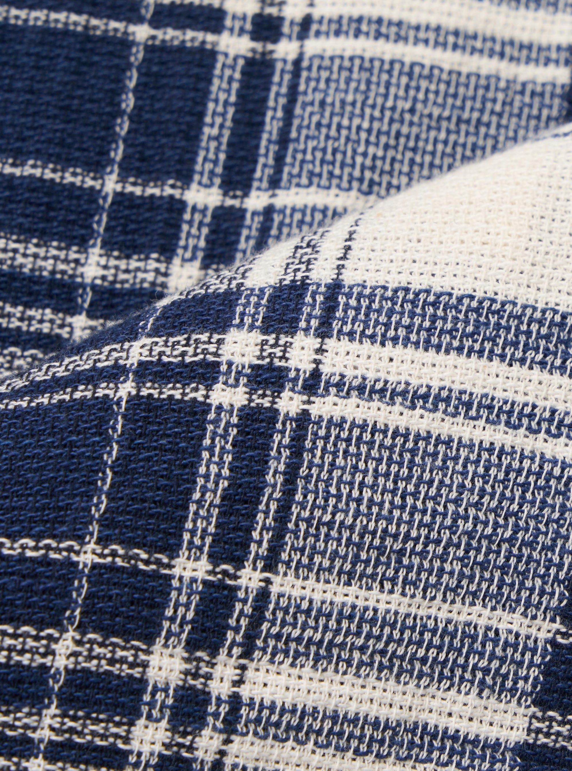 A close-up swatch image of the Navy Texture Plaid Zip Shirt fabric displays a deep navy blue and white checkered plaid pattern. The image highlights the intricate texture of the cotton fabric and the detailed weave of the plaid design.
