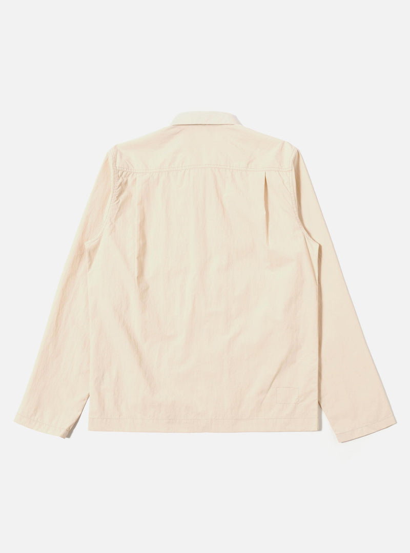 The Stone Seo Recycled Nylon Zip Too Shirt is shown from a rear angle as a flat lay against a plain white background. The image highlights the smooth texture of the stone-colored recycled nylon fabric, the straight hem, and the simple construction of the back panel.