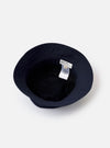 The Navy Recycled Polytech Beach Hat is shown from a side angle as a flat lay against a plain white background. The bucket-style hat features a structured crown with tonal stitching and a wide, downward-sloping brim. The dark navy fabric has a smooth, technical finish.