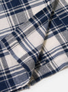 The Navy Texture Plaid Cancun Jacket is displayed as a flat lay against a plain white background. The image provides a close-up detail of the jacket's lower front, highlighting a large patch pocket and the textured navy blue plaid pattern of the cotton fabric.