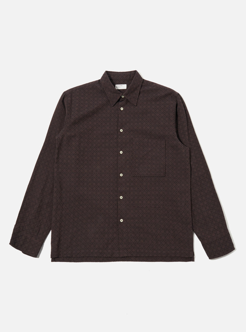 The Brown Diamond Dobby Lucky Shirt is shown as a flat lay against a white background. The shirt features a button-front fastening, a classic collar, and a single patch pocket on the left chest. The brown cotton fabric has a visible textured diamond dobby pattern throughout.