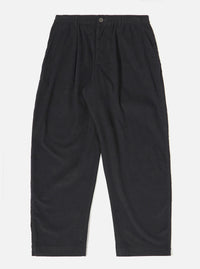 The Black Organic Fine Cord Oxford Pant is shown as a flat lay against a white background. The trousers feature a wide leg with a slight taper, a single pleat front, and an elasticated waistband with a drawstring. The garment is made from a black organic fine-wale cotton corduroy.