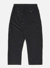 The Black Organic Fine Cord Oxford Pant is shown from the back as a flat lay against a plain white background. The image highlights the two rear pockets, one with a buttoned flap and one button jetted, as well as the elasticated waistband. The black organic cotton fabric has a visible fine corduroy texture.