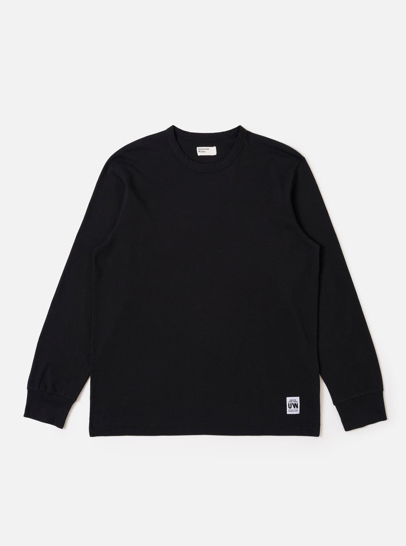 The Black Recycled/Bio Jersey Henry L/S Tee is presented as a flat lay against a plain white background. This long-sleeve t-shirt features a crew neckline, ribbed cuffs, and a straight hem. The garment is made from a solid black recycled and organic cotton jersey fabric.
