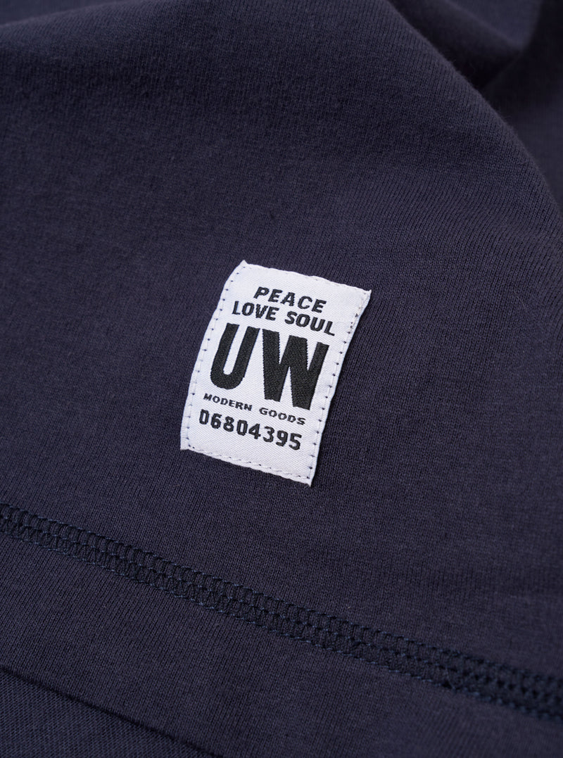 The Navy Recycled/Bio Jersey Henry L/S Tee is shown from the back as a flat lay against a plain white background. The long-sleeve t-shirt features a ribbed crew neckline and a straight hem. The dark navy blue jersey fabric has a smooth, uniform appearance.