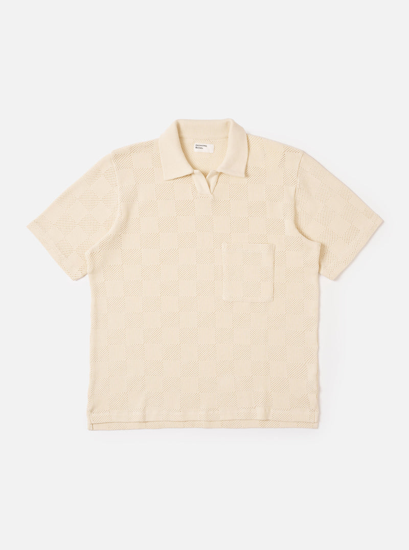 The Ecru Fantasy Checkerboard Vacation Polo is shown as a flat lay against a white background. The shirt features an all-over checkerboard pattern in ecru and beige tones, an open collar with a short placket, and a single patch pocket on the chest. The short-sleeved polo has a straight hem with small side vents.