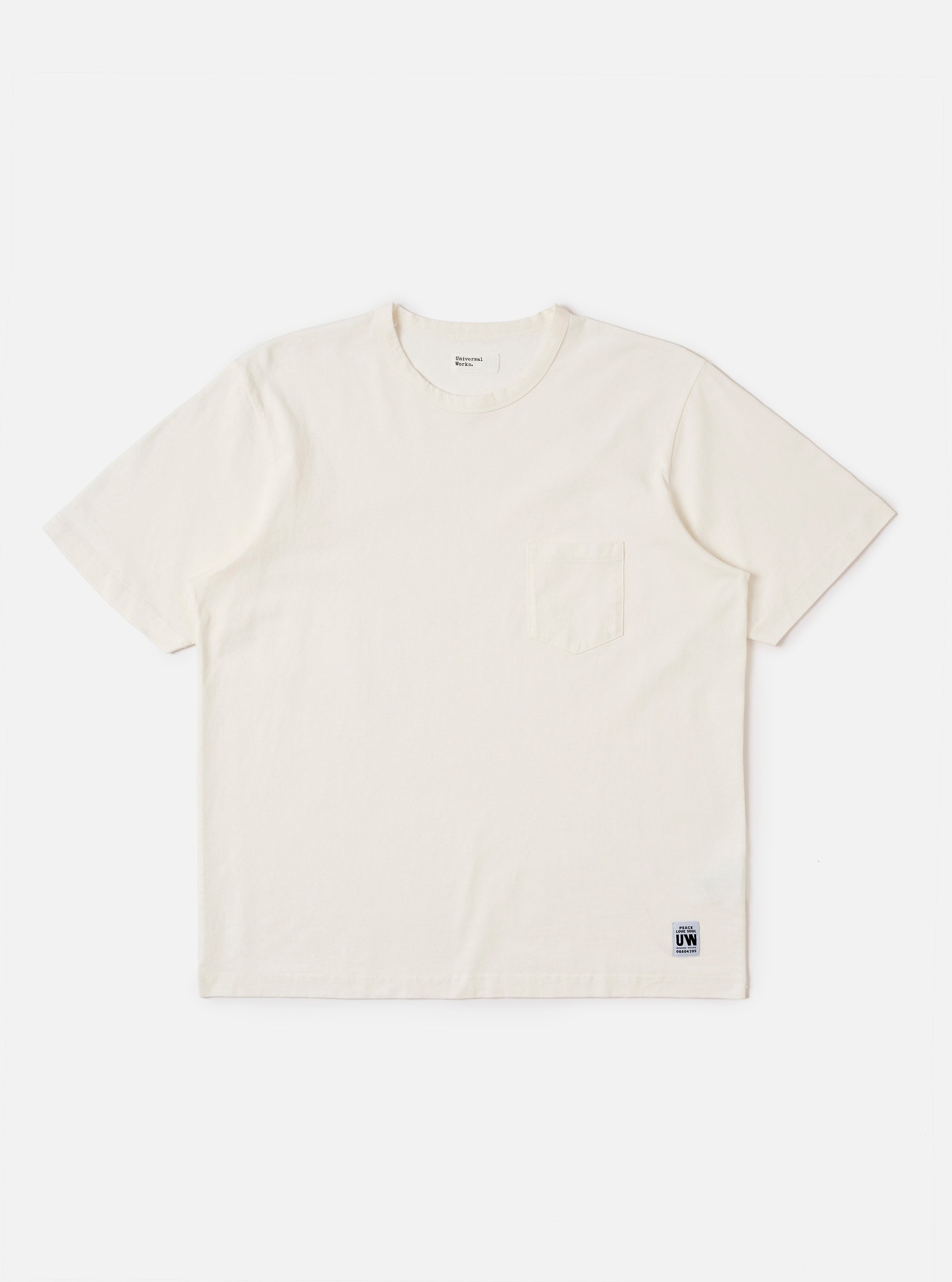 The Antique White Recycled/Bio Jersey Core Pocket Tee is shown as a flat lay against a plain white background. The T-shirt features a classic crew neckline, short sleeves, and a single patch pocket on the left chest. The fabric is a solid antique white jersey with a smooth texture.