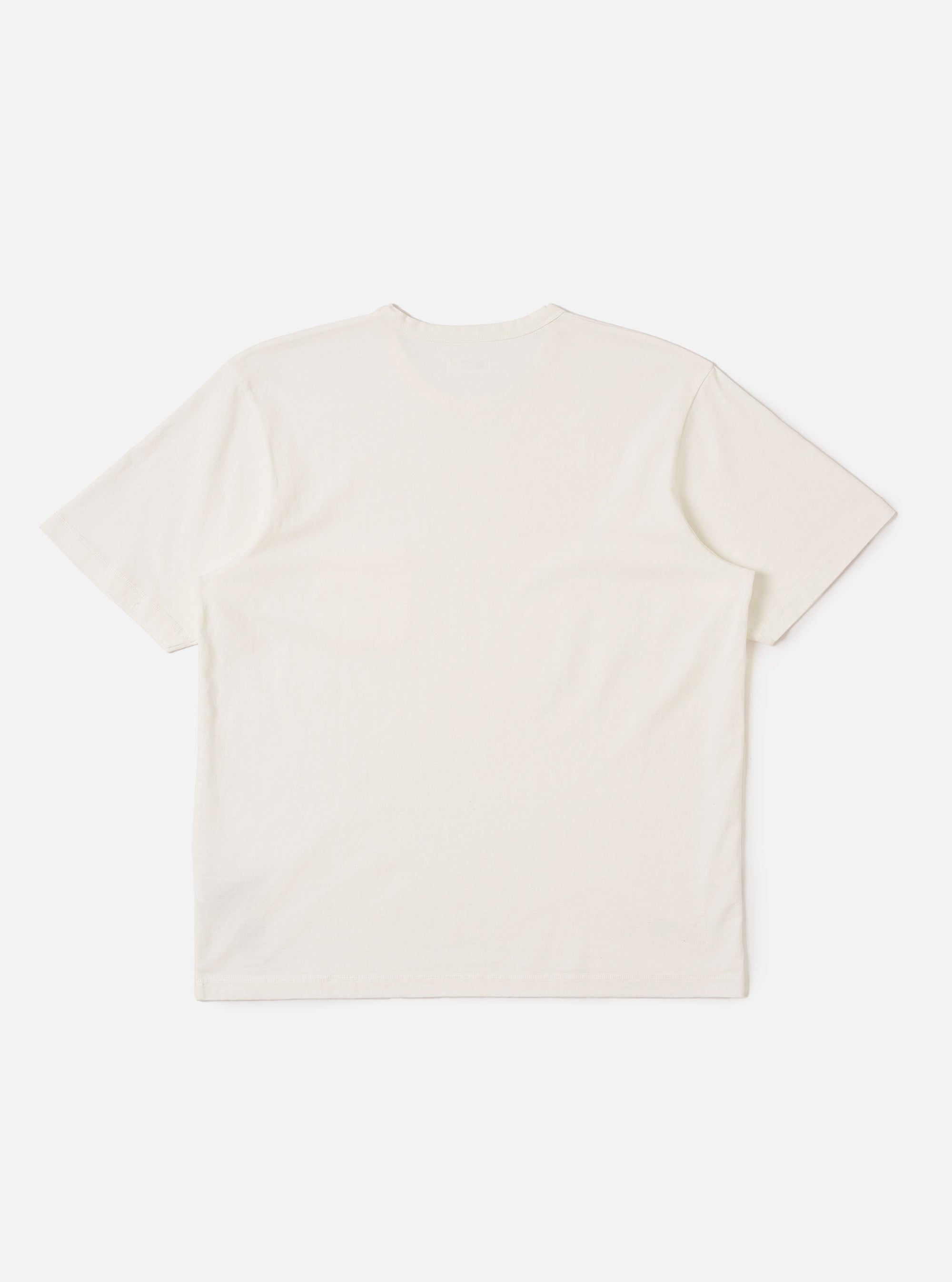 The Antique White Recycled/Bio Jersey Core Pocket Tee is shown from the back as a flat lay against a plain white background. The image highlights the clean, simple construction of the t-shirt, featuring a ribbed crew neckline and a straight hem. The fabric is a solid antique white jersey with a smooth texture.