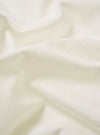 The Antique White Recycled/Bio Jersey Core Pocket Tee is shown in a detail view as a flat lay against a plain white background. The image highlights the textured antique white jersey fabric, the ribbed crew neckline, and the stitching of the front chest pocket.