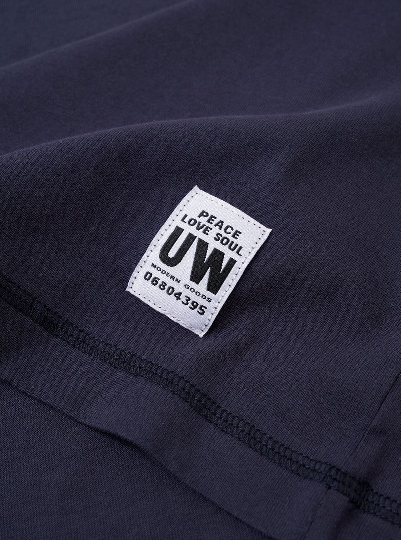 The Navy Recycled/Bio Jersey Core Pocket Tee is shown from the back as a flat lay against a plain white background. The image highlights the smooth texture of the navy blue jersey fabric, the short sleeves, and the ribbed crew neckline.