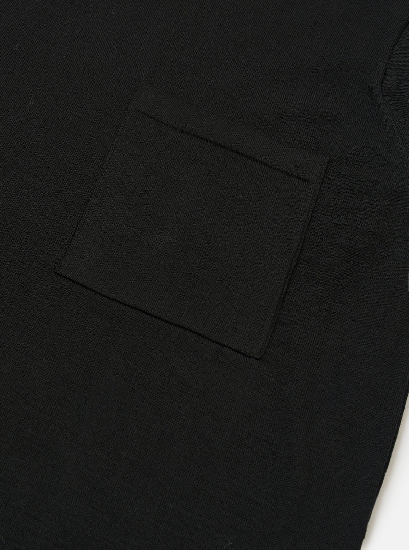 The Black Woolcot Bio S/S Pullover Knit Shirt II is shown from the back as a flat lay against a plain white background. The image highlights the shirt's boxy fit, short sleeves, and a large one-piece collar. The black knit fabric appears smooth and lightweight.
