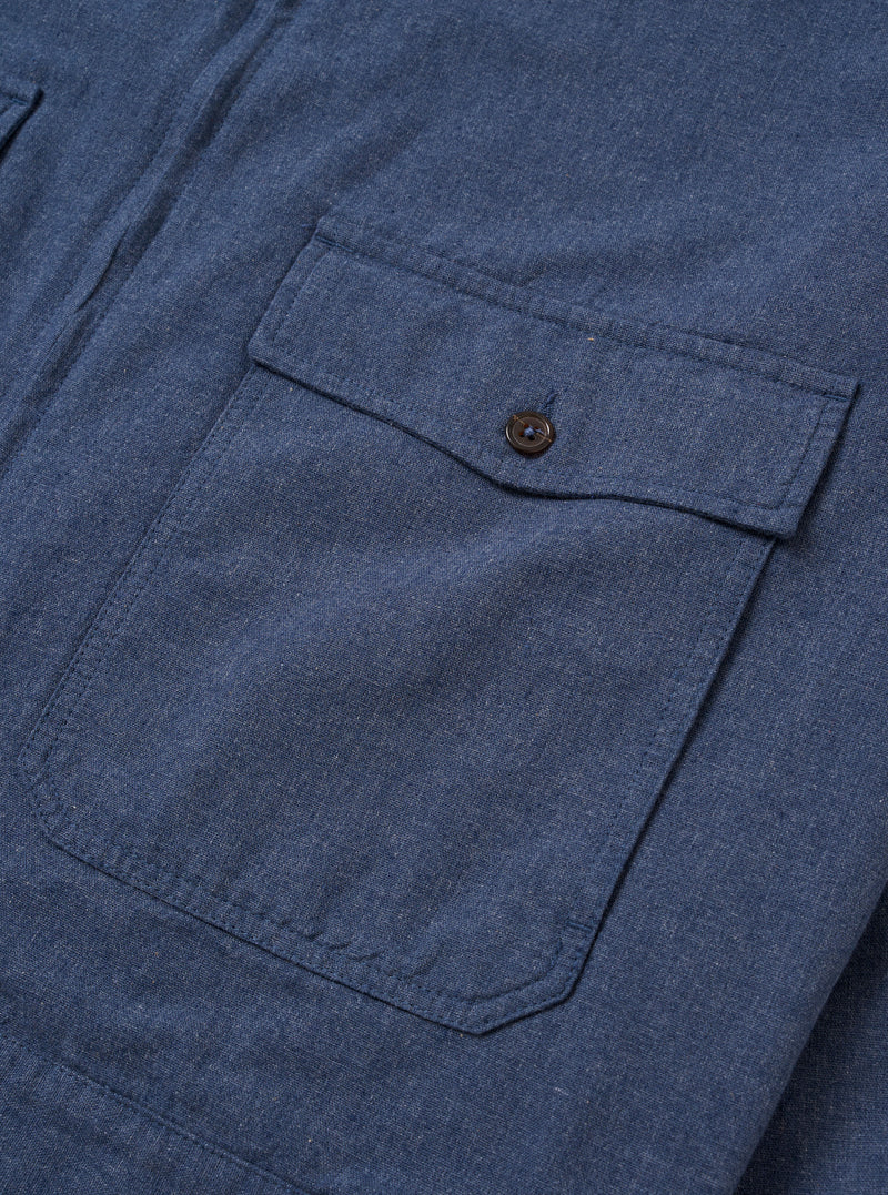 The Blue Sintra Recycled Cotton E130 Jacket is shown from the back as a flat lay against a plain white background. The image highlights the clean, simple construction of the garment's rear, featuring a straight hem and a standard pointed collar. The recycled cotton fabric is a solid, mid-blue color with a smooth texture.