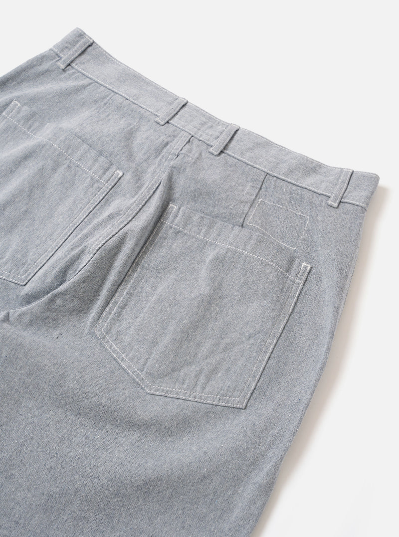 The Light Indigo Jean Cloth Reworked Duke Pant is shown from the back as a flat lay against a plain white background. The image highlights the two rear patch pockets and the wide-leg silhouette of the trousers. The light indigo organic cotton fabric features a textured, multi-tonal appearance.