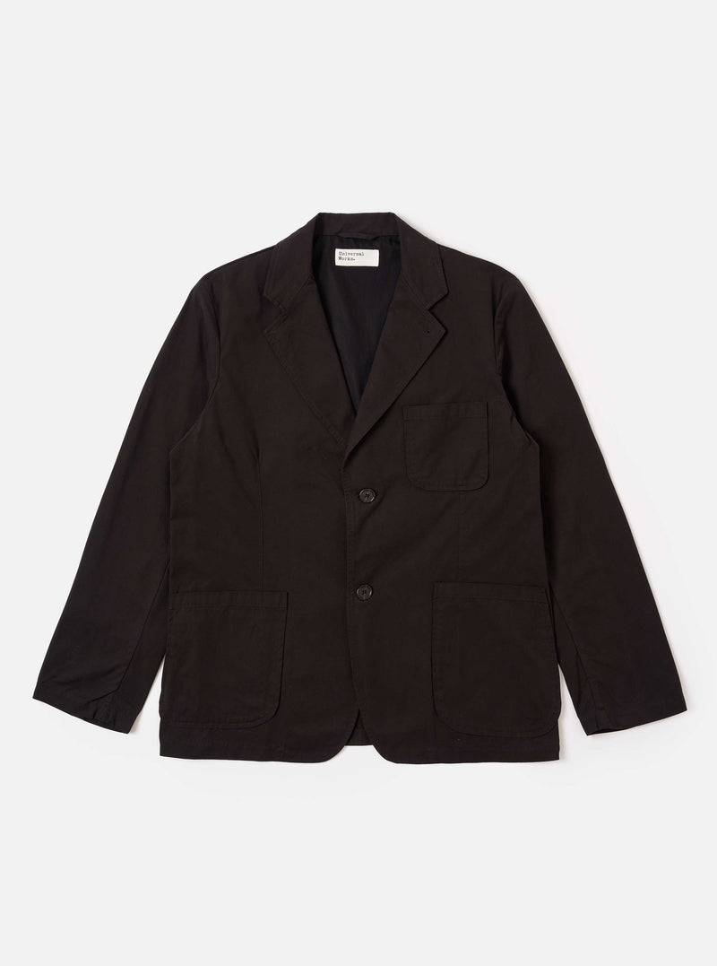 The Licorice Summer Canvas Two Button Jacket is presented as a flat lay against a solid white background. The jacket features a notched lapel, two-button front closure, a single chest patch pocket, and two large patch pockets at the waist. The cotton canvas fabric has a rich brown color and a subtle, textured appearance.