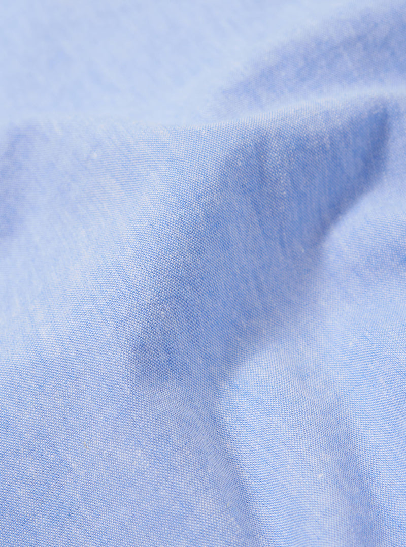 A close-up fabric swatch of the Sky Blue Sido Linen Mix Road Shirt is shown, highlighting the soft sky blue color and the subtle, textured weave of the cotton-linen blend.