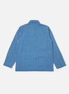 The Washed Indigo Recycled Herringbone Smock Overshirt is shown from the back as a flat lay against a plain white background. The image highlights the textured herringbone weave of the recycled cotton fabric and the tonal variations of the washed indigo blue color. The back features a clean, simple construction with a straight hem and a horizontal yoke across the shoulders.
