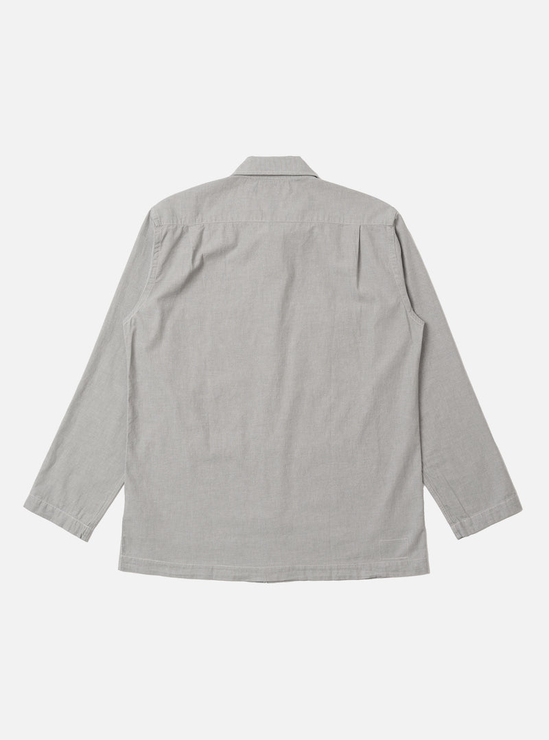 The Grey Izumi Cotton Dockside is shown from the back as a flat lay against a plain white background. The overshirt features a simple, straight-cut back panel with a horizontal yoke across the shoulders and a straight hem. The grey cotton fabric has a fine, smooth texture.