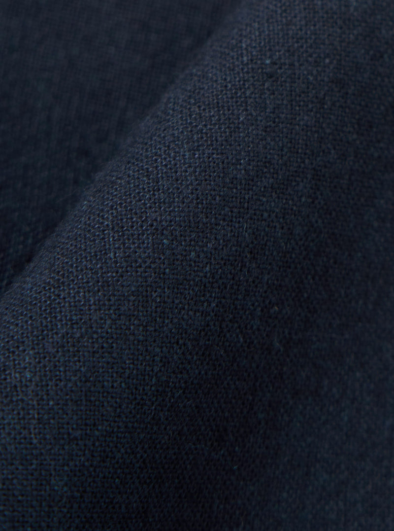 A close-up fabric swatch of the Navy Valencia Cotton Military Chino is shown, highlighting the dark navy blue color and the textured, woven character of the cotton-blend fabric.