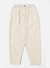 The Ecru Koko Cotlin Pleated Track Pant is shown as a flat lay against a white background. The trousers feature a single pleat at the front, a tapered leg, and an elasticated waistband with a visible drawstring. The light ecru fabric has a textured, slubby appearance.
