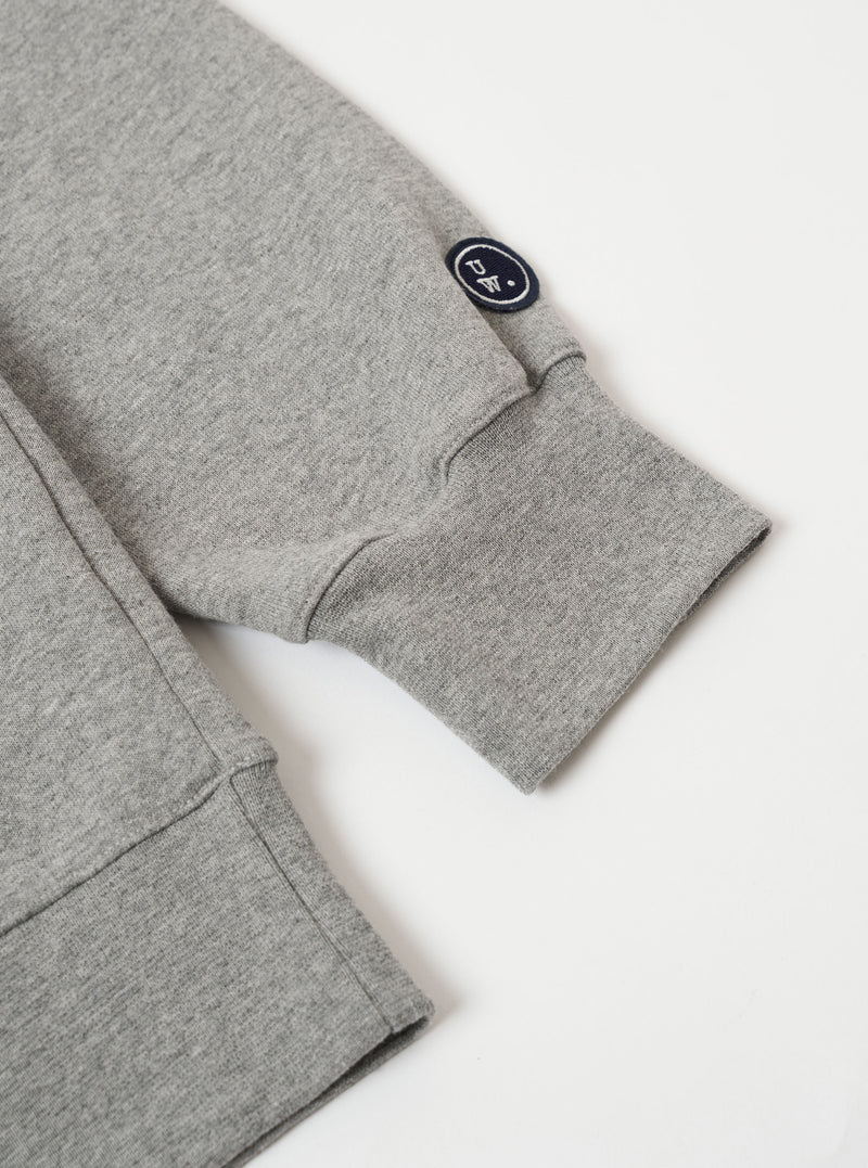 The Grey Marl Recycled Cotton Blend Jersey Loose Sweatshirt is shown from the back as a flat lay against a plain white background. The image highlights the sweatshirt's relaxed, loose fit, its ribbed crew neck, and the elasticated ribbed hem and cuffs. The fabric has a soft, textured grey marl appearance.