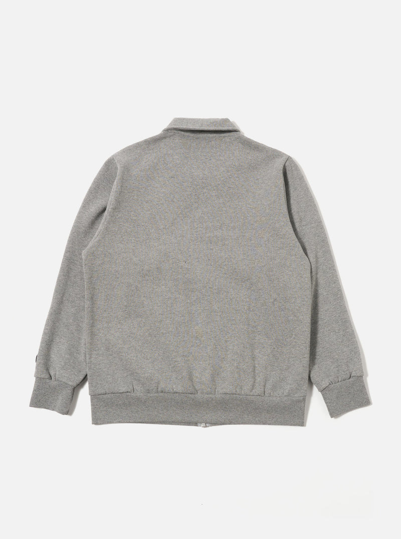 The Grey Marl Recycled Cotton Blend Jersey Tyler Jacket is shown from the back as a flat lay against a plain white background. The image highlights the jacket's simple construction, featuring a straight back panel, a structured collar, and ribbed detailing at the cuffs and hem. The grey marl fabric has a soft, heathered appearance.