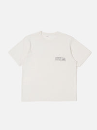 The Ecru Organic Jersey Print Pocket Tee is shown as a flat lay against a white background. The t-shirt features a crew neckline, short sleeves, and a single chest pocket on the left side with a graphic print. The fabric is a solid ecru organic cotton jersey.