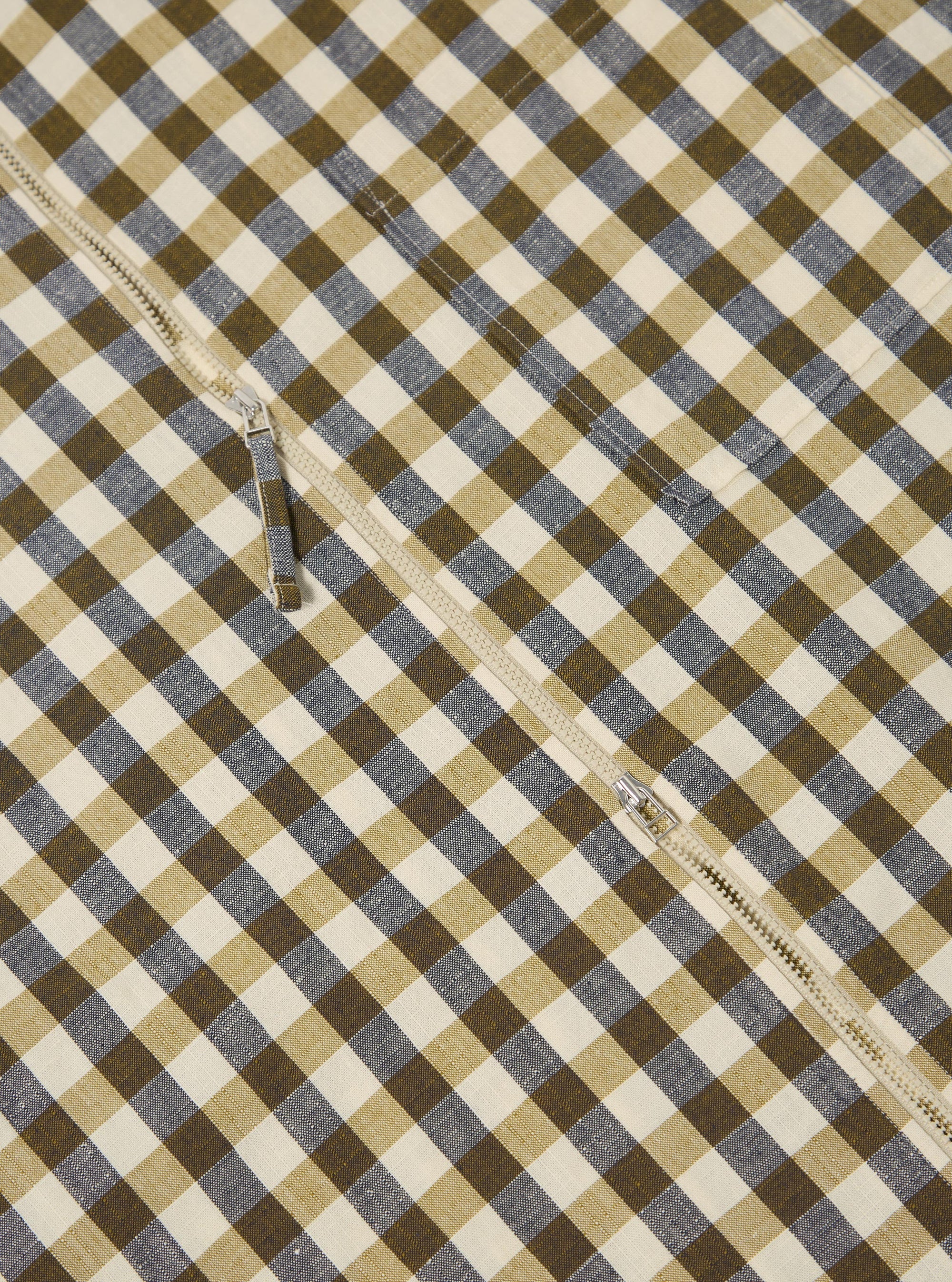 The Olive Aberdeen Lincot Zip Shirt is shown from the back as a flat lay against a plain white background. The image highlights the shirt's simple back yoke, straight hem, and long sleeves with buttoned cuffs. The fabric features a subtle olive green check pattern.