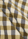 A close-up fabric swatch of the Olive Aberdeen Lincot Zip Shirt highlights the olive green color and subtle check pattern. The image showcases the textured weave of the cotton and linen blend material.