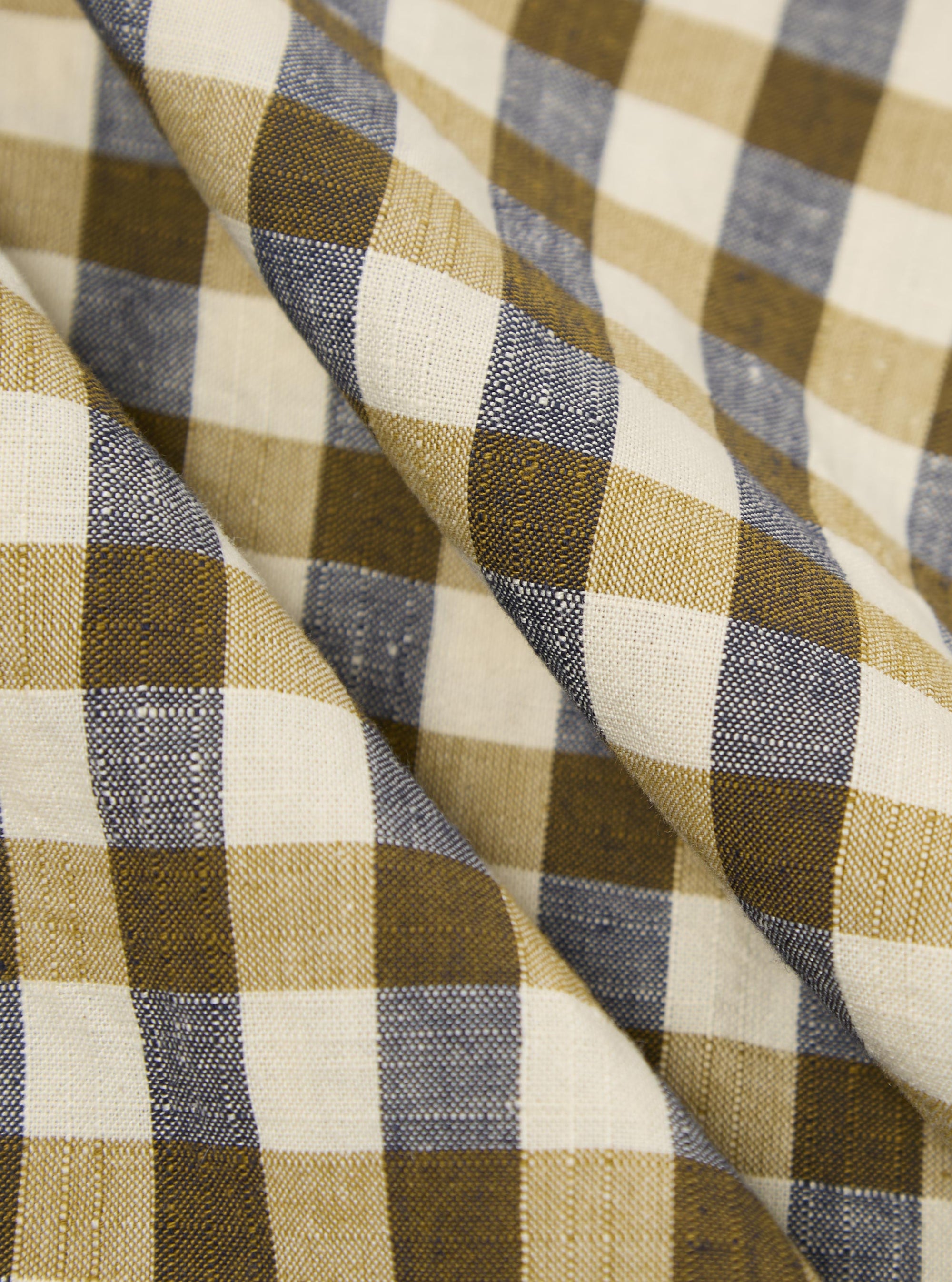 A close-up fabric swatch of the Olive Aberdeen Lincot Zip Shirt highlights the olive green color and subtle check pattern. The image showcases the textured weave of the cotton and linen blend material.