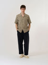 The Olive Aberdeen Lincot Road Shirt is shown as a flat lay against a plain white background. This short-sleeve shirt features a one-piece camp collar with a loop closure, a full button-down front, and a single chest patch pocket. The olive green fabric, a blend of cotton and linen, displays a subtle natural texture and a straight hem.