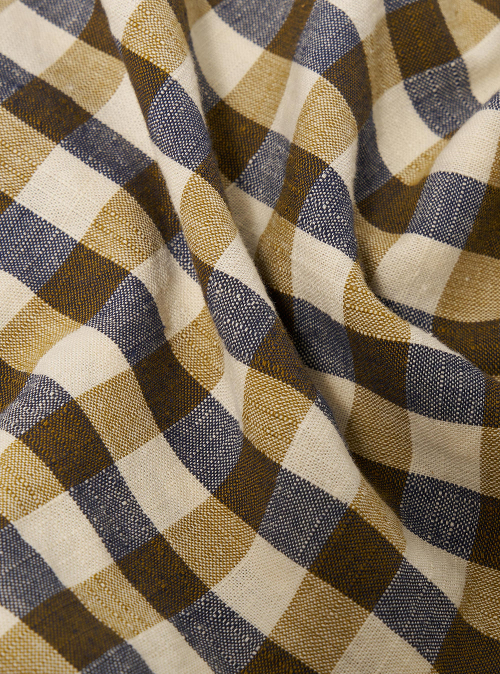 A close-up fabric swatch of the Olive Aberdeen Lincot Road Shirt highlights the textured weave and rich olive green color of the cotton-linen blend. The fabric fills the entire frame, showcasing the material's matte finish and natural irregularities.