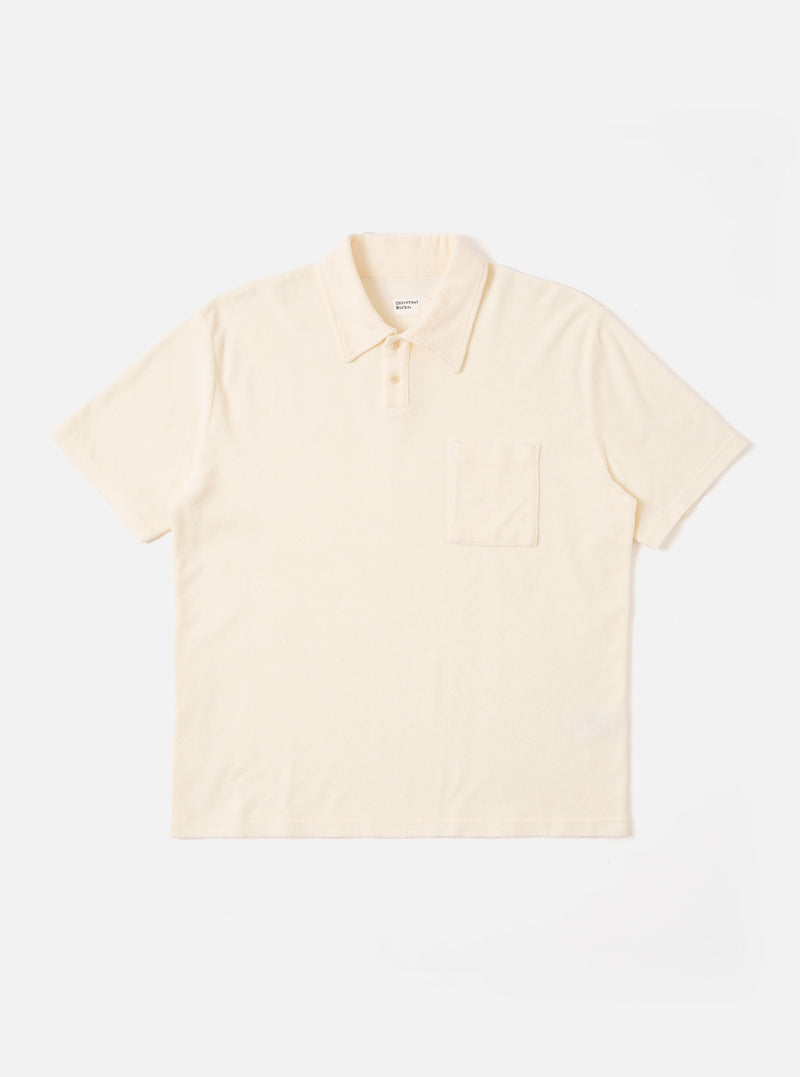 The Ecru Light Weight Terry Newlyn Polo is shown as a flat lay against a white background. The polo features a classic collar, a short button placket, and short sleeves. The fabric has a visible textured light weight terry finish in a soft ecru color.