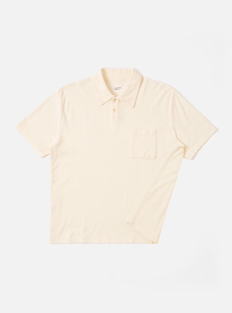 The Ecru Light Weight Terry Newlyn Polo is shown as a flat lay against a white background. The shirt features a polo collar, a three-button front closure, and a single patch pocket on the left chest. The garment is made from a light-colored terry fabric with a soft, fluffy texture.