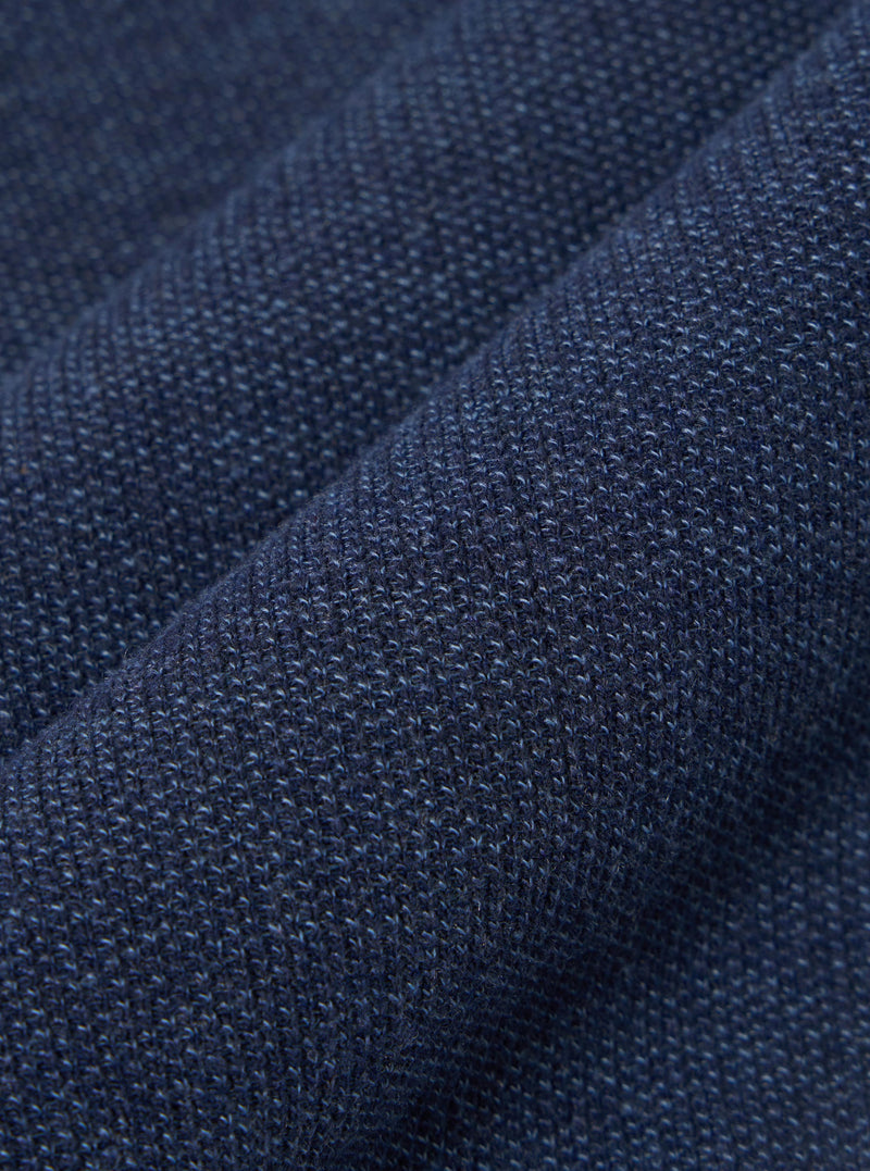 A close-up swatch image of the Navy Maiorca Jersey Cardigan fabric highlights a textured, woven pattern in a deep navy blue. The fabric has a distinct interlaced appearance with subtle variations in color.