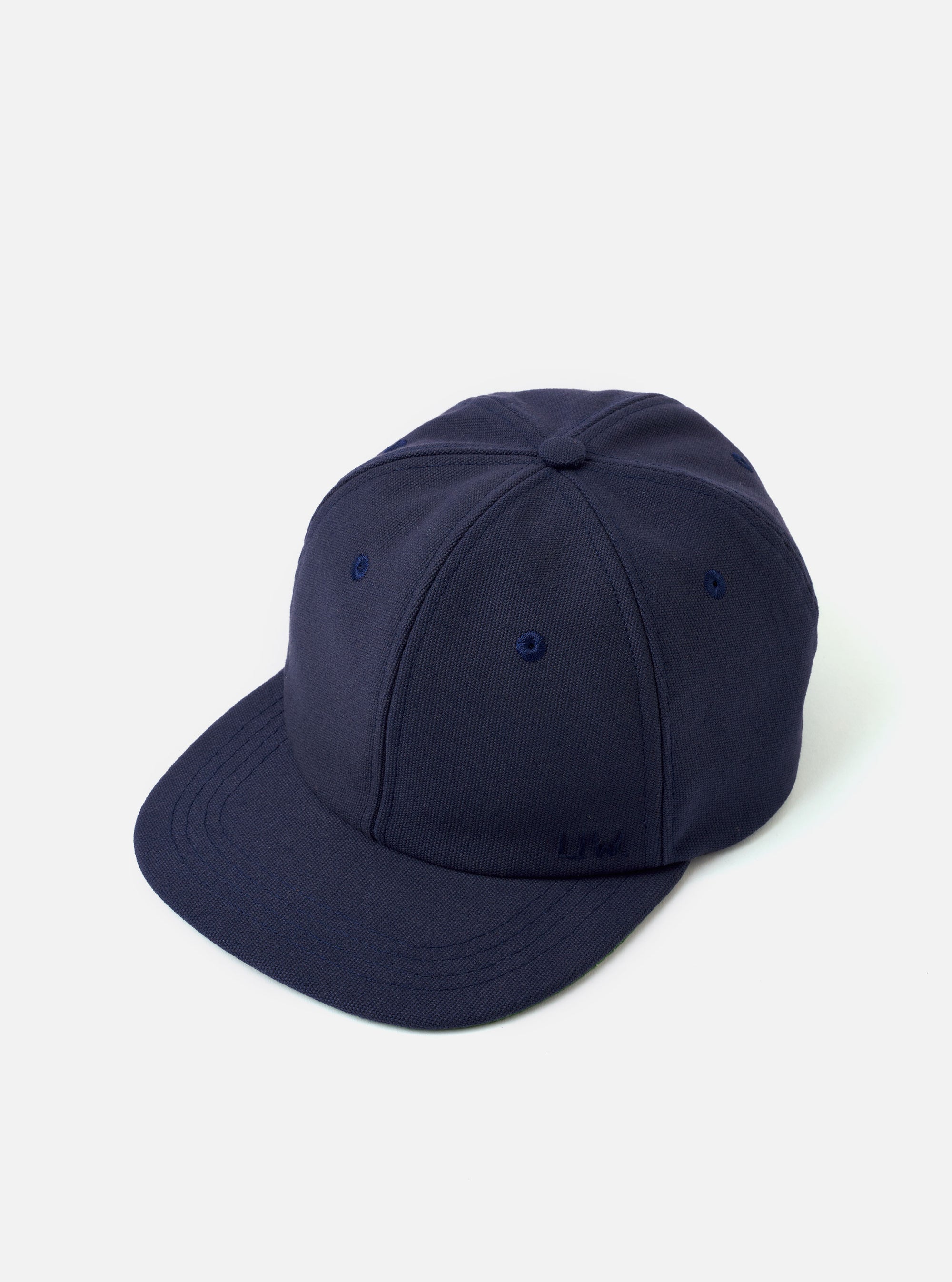 The Navy Canvas Baseball Hat is shown from the back as a flat lay against a plain white background. The image highlights the adjustable strap with a metal buckle and the clean stitching of the navy blue cotton canvas fabric.