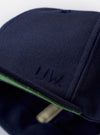 The Navy Canvas Baseball Hat is shown from the back as a flat lay against a plain white background. The image highlights the adjustable strap with a silver-tone metal buckle and the clean stitching around the crown. The hat is made from a durable navy blue cotton canvas fabric.